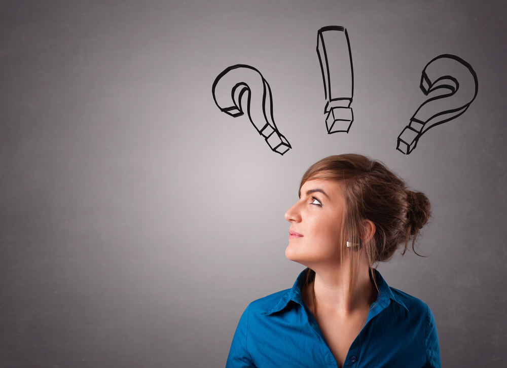 Beautiful young lady thinking with question marks overhead Beautiful young lady thinking with question marks overhead